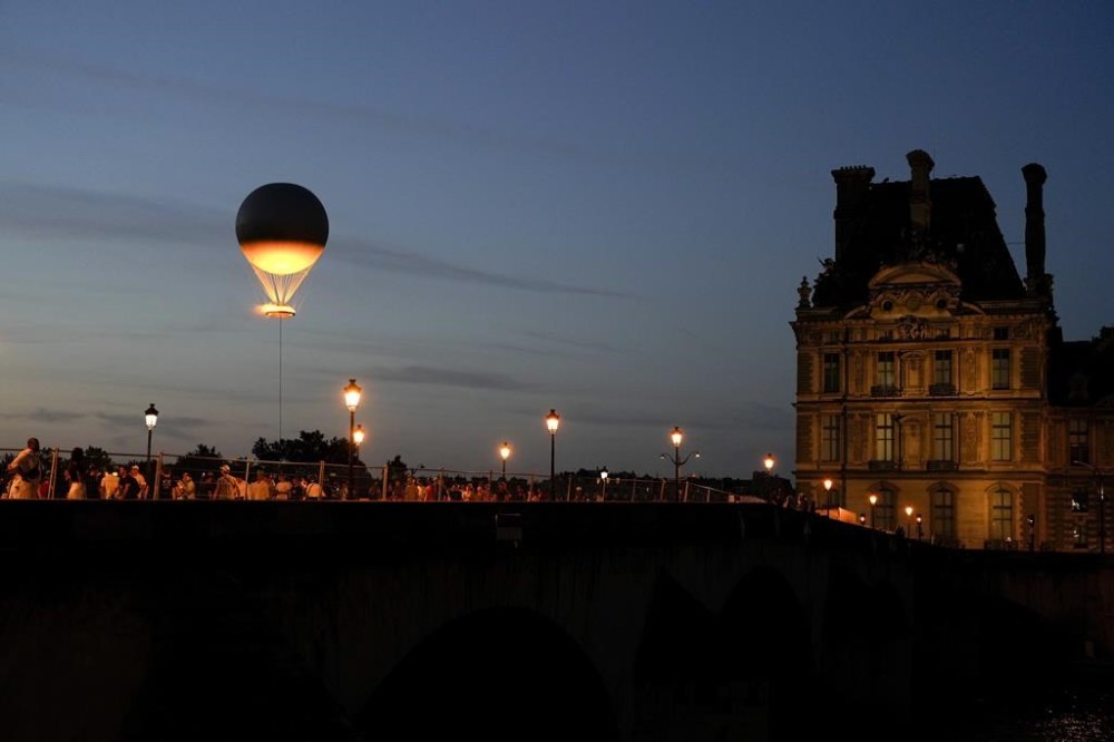 The Olympic cauldron beams at sunset in the Tuileries Garden during the 2024 Summer Olympics, Monday, July 29, 2024, in Paris, France. (AP Photo/Natacha Pisarenko)