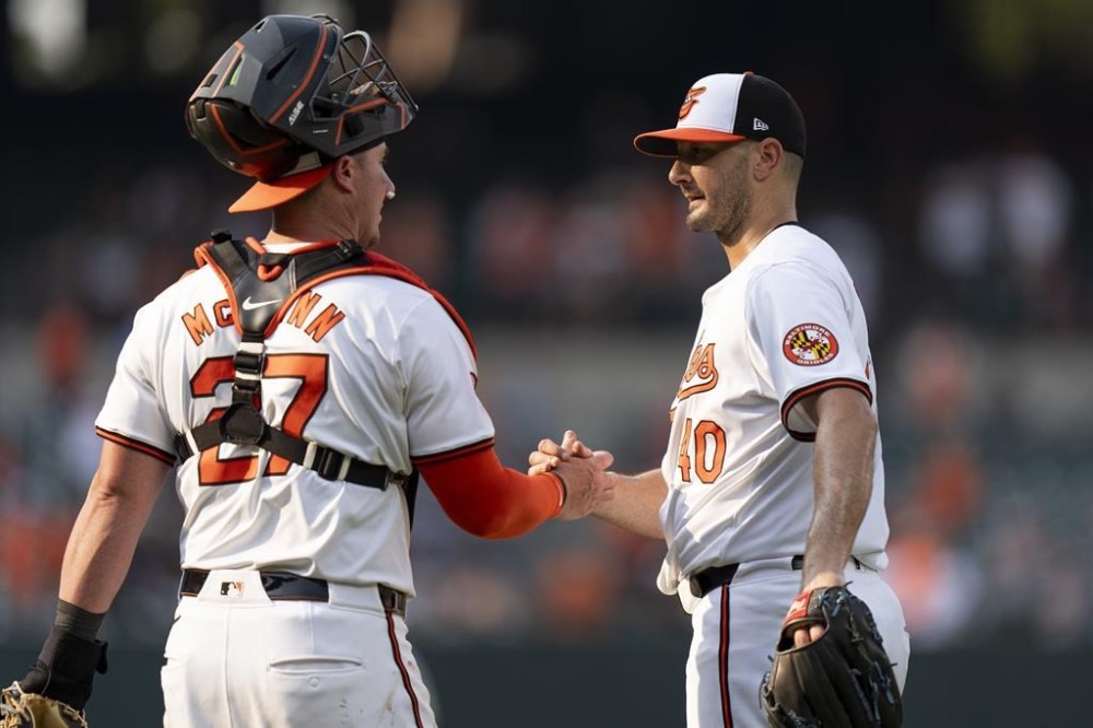 Baltimore Orioles catcher James McCann (27) and relief pitcher Burch Smith (40) celebrate after their win over the Toronto Blue Jays in the first baseball game of a doubleheader, Monday, July 29, 2024, in Baltimore. (AP Photo/Stephanie Scarbrough)