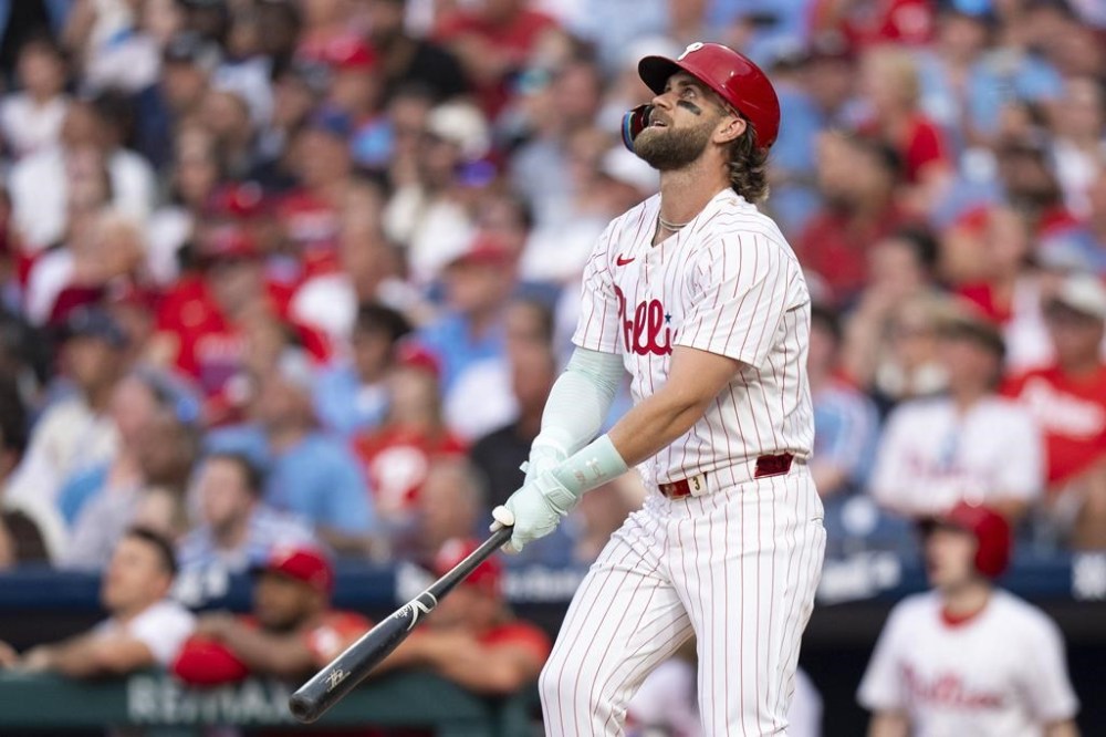 Philadelphia Phillies' Bryce Harper watches as he flies out to end the third inning of a baseball game against the New York Yankees, Monday, July 29, 2024, in Philadelphia. (AP Photo/Chris Szagola)