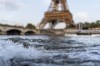 Waves crash along the banks of the Seine River in front of the Eiffel Tower during the 2024 Summer Olympics, Monday, July 29, 2024, in Paris. As the Olympics continue in Paris, the Seine River's water quality remains a major area of concern for officials. Organizers of the triathlon event cancelled swimming practice on Monday for the second day in a row because of poor water quality. Event organizers hope sunny weather will make swimming viable on Tuesday when the triathlon begins. (AP Photo/David Goldman)