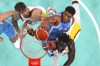 Giannis Antetokounmpo, center, of Greece, dunks as Juancho Hernangomez, of Spain, and Usman Garuba, left, of Spain, defend at the 2024 Summer Olympics, Tuesday, July 30, 2024, in Villeneuve-d'Ascq, France. (Evelyn Hockstein/Pool Photo via AP)