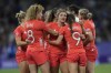 Great Britain's Amy Wilson Hardy, center joins her teammates in a huddle after they lost their women's quarterfinal Rugby Sevens match between Great Britain and the United States at the 2024 Summer Olympics, in the Stade de France, in Saint-Denis, France, Monday, July 29, 2024. The US won the game 17-7. (AP Photo/Tsvangirayi Mukwazhi)