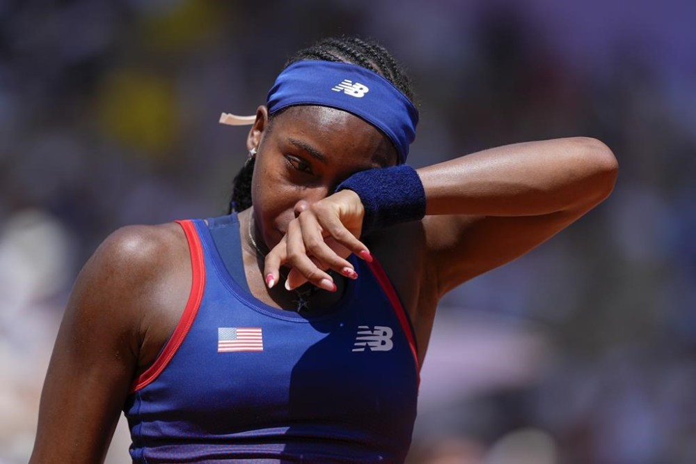 Coco Gauff of United States wipes her tears after arguing with the umpires during her women's singles third round match against Donna Vekic of Croatiathe, at the 2024 Summer Olympics, Tuesday, July 30, 2024, at the Roland Garros stadium in Paris, France. (AP Photo/Andy Wong)