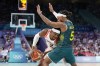 Canada's Shai Gilgeous-Alexander, left, tires to get by Australia's Patty Mills in a men's basketball game at the 2024 Summer Olympics, Tuesday, July 30, 2024, in Villeneuve-d'Ascq, France. THE CANADIAN PRESS/AP/Michael Conroy