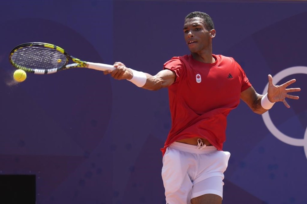 Felix Auger-Aliassime of Canada returns the ball against Maximilian Marterer of Germany during the men's single tennis competition at the Roland Garros stadium, at the 2024 Summer Olympics, Tuesday, July 30, 2024, in Paris, France. THE CANADIAN PRESS/AP/Manu Fernandez