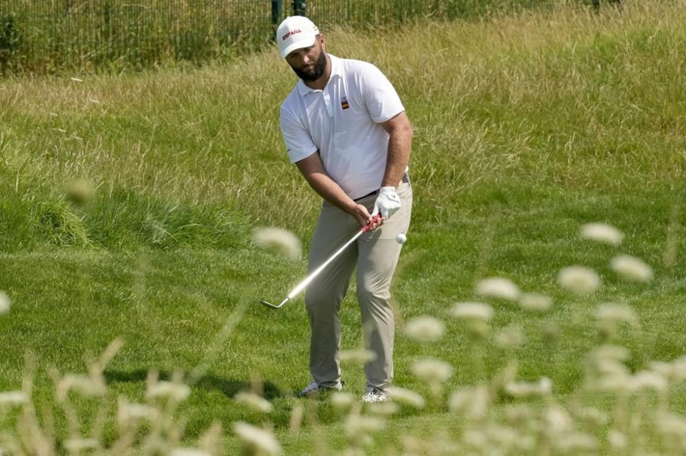 Jon Rahm, of Spain, chips onto the sixth green during a practice round for the men's golf event at the 2024 Summer Olympics, Tuesday, July 30, 2024, at Le Golf National in Saint-Quentin-en-Yvelines, France. (AP Photo/Matt York)