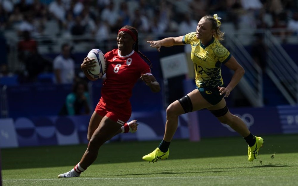 Canada's Charity Williams outruns Australia's Maddison Levi as she runs in to score at the end of first half of women's rugby sevens semi-final action, Tuesday, July 30, 2024 in Paris. THE CANADIAN PRESS/Adrian Wyld