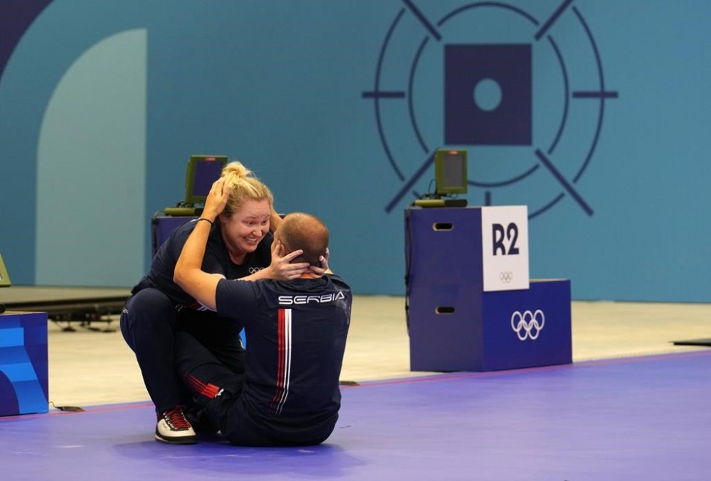 Serbia's Damir Mikec and Zorana Arunovic, left, celebrate after winning the gold medal in the 10m air pistol mixed team event at the 2024 Summer Olympics, Tuesday, July 30, 2024, in Chateauroux, France. (AP Photo/Manish Swarup)