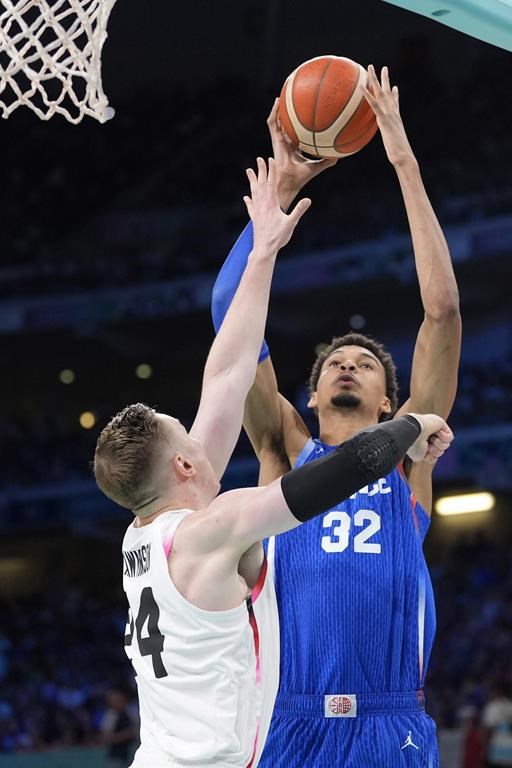 France's Victor Wembanyama, right, shoots as Japan's Josh Hawkinson defends in a men's basketball game at the 2024 Summer Olympics, Tuesday, July 30, 2024, in Villeneuve-d'Ascq, France. (AP Photo/Michael Conroy)