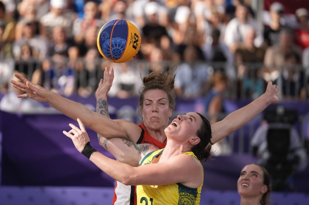Marena Whittle of Australia, front, and Michelle Plouffe of Canada clash in the women's 3x3 basketball pool round match between Australia and Canada at the 2024 Summer Olympics, Tuesday, July 30, 2024, in Paris, France. (AP Photo/Rebecca Blackwell)