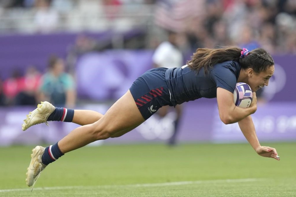 United States' Alex Sedrick scores the winning try during the women's bronze medal Rugby Sevens match between the United States and Australia at the 2024 Summer Olympics, in the Stade de France, in Saint-Denis, France, Tuesday, July 30, 2024. The US won the match 14-12. (AP Photo/Vadim Ghirda)