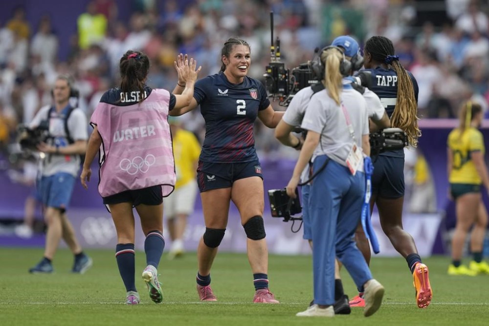 United States' Ilona Maher goes towards teamed United States' Naya Tapper after the team won the women's bronze medal Rugby Sevens match between the United States and Australia at the 2024 Summer Olympics, in the Stade de France, in Saint-Denis, France, Tuesday, July 30, 2024. The US won the match 14-12. (AP Photo/Vadim Ghirda)