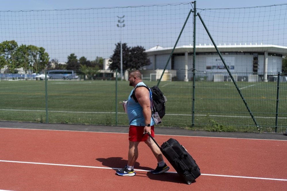 Shot putter Joe Kovacs walks off the field after a practice session at the Team USA training facility at the 2024 Summer Olympics, Tuesday, July 30, 2024, in Eaubonne, France. (AP Photo/David Goldman)