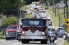 A Saxonburg, Pa. fire truck carrying the casket of Cory Comperatore, leads a procession of fire vehicles following a memorial service at Cabot United Methodist Church in Cabot, Pa., Friday, July 19, 2024. Comperatore, a former fire chief, was shot and killed at a rally where a gunman tried to assassinate former President Donald Trump. (AP Photo/Gene J. Puskar)