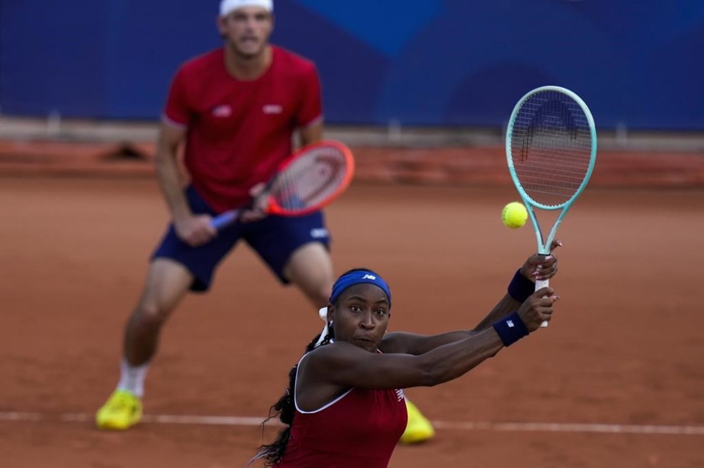 Coco Gauff and Taylor Fritz of United States play against Nadia Podoroska and Maximo Gonzalez of Argentina during their mix doubles match at the Roland Garros stadium, at the 2024 Summer Olympics, Tuesday, July 30, 2024, in Paris, France. (AP Photo/Andy Wong)