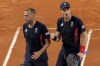 Andy Murray, right, and Daniel Evans of Britain celebrate a point during their match against Joran Vliegen and Sander Gille of Belgium during the men's doubles tennis competition at the Roland Garros stadium, at the 2024 Summer Olympics, Tuesday, July 30, 2024, in Paris, France. (AP Photo/Manu Fernandez)