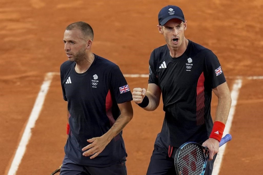 Andy Murray, right, and Daniel Evans of Britain celebrate a point during their match against Joran Vliegen and Sander Gille of Belgium during the men's doubles tennis competition at the Roland Garros stadium, at the 2024 Summer Olympics, Tuesday, July 30, 2024, in Paris, France. (AP Photo/Manu Fernandez)