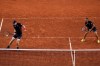 Andy Murray, left, and Daniel Evans of Britain compete against Joran Vliegen and Sander Gille of Belgium during the men's doubles tennis competition at the Roland Garros stadium, at the 2024 Summer Olympics, Tuesday, July 30, 2024, in Paris, France. (AP Photo/Manu Fernandez)