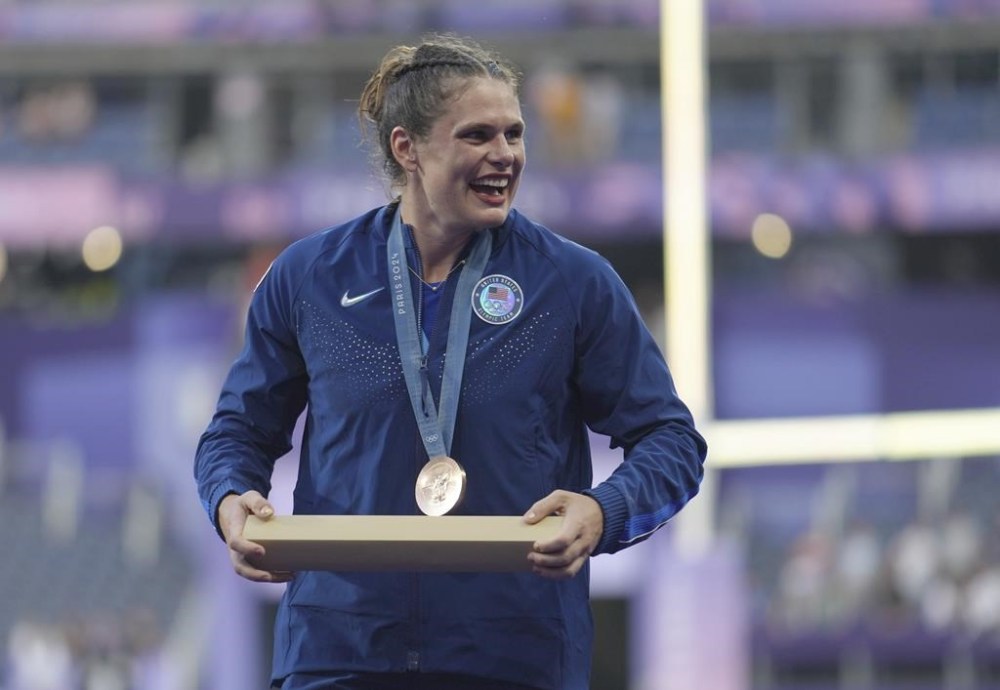 United States' Ilona Maher smiles as she leaves the medal presentation ceremony with her bronze medal for the Rugby Sevens at the 2024 Summer Olympics, in the Stade de France, in Saint-Denis, France, Tuesday, July 30, 2024. (AP Photo/Tsvangirayi Mukwazhi)