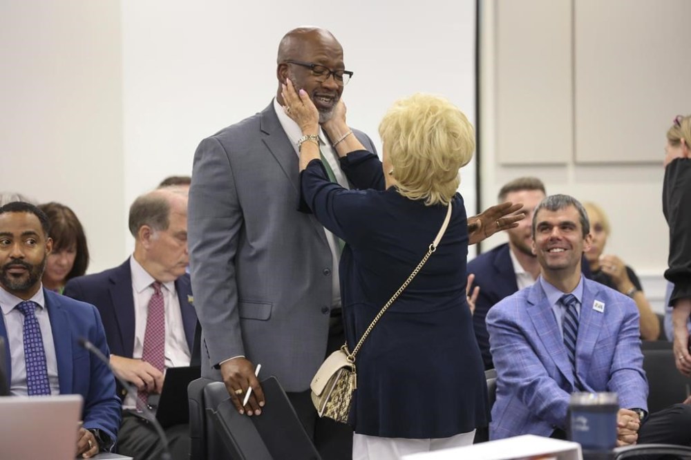 St. Petersburg Mayor Ken Welch visits with Pinellas County Commissioner Janet Long while attending a meeting of the Pinellas County commissioners on Tuesday, July 30, 2024, where they voted for funding for a new Tampa Bay Rays ballpark, in Clearwater, Fla. (Douglas R. Clifford/Tampa Bay Times via AP)
