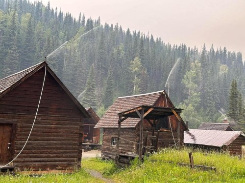 BC Wildfire crews work to protect the Barkerville Town and Park heritage site from the nearby Antler Creek wildfire in Barkerville, B.C., in an undated handout photo. Barkerville is reopening Friday after a nearby wildfire forced residents and tourists to evacuate the region. THE CANADIAN PRESS/HO-Carrie Chard, *MANDATORY CREDIT*