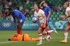 Canada's Jessie Fleming holds the ball as she celebrates after scoring her side's opening goal during the women's Group A soccer match between Canada and France at Geoffroy-Guichard stadium during the 2024 Summer Olympics, Sunday, July 28, 2024, in Saint-Etienne, France. (AP Photo/Silvia Izquierdo)