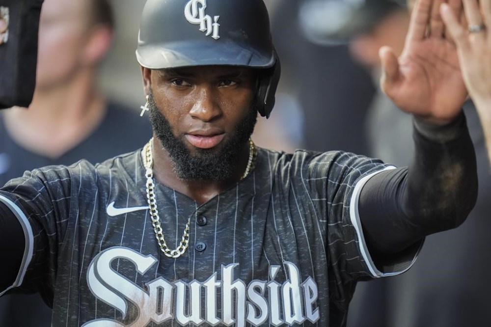 Chicago White Sox's Luis Robert Jr. celebrates after scoring on a single from Gavin Sheets during the first inning of a baseball game against the Kansas City Royals, Monday, July 29, 2024, in Chicago. (AP Photo/Erin Hooley)