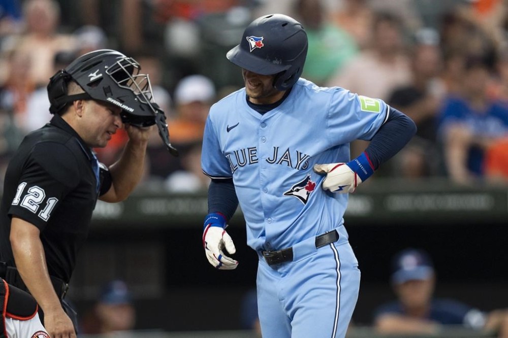 Toronto Blue Jays' Ernie Clement reacts after being hit by a pitch delivered by Baltimore Orioles starting pitcher Corbin Burnes during the fourth inning of a baseball game Tuesday, July 30, 2024, in Baltimore. (AP Photo/Stephanie Scarbrough)