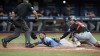 Tampa Bay Rays' Jose Caballero, center, steals home plate as the ball skips away from Miami Marlins catcher Nick Fortes, right, during the seventh inning of a baseball game Tuesday, July 30, 2024, in St. Petersburg, Fla. Making the call is home plate umpire Tripp Gibson. (AP Photo/Christopher O'Meara)