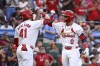 St. Louis Cardinals' Masyn Winn (0), right, is congratulated by teammate Alec Burleson after hitting a solo home run in the first inning of a baseball game against the Texas Rangers, Tuesday, July 30, 2024, in St. Louis. (AP Photo/Joe Puetz)