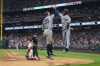 New York Yankees' Jazz Chisholm Jr., right, celebrates his three-run home run with Aaron Judge, center, as Philadelphia Phillies catcher J.T. Realmuto, left, looks on during the seventh inning of a baseball game, Tuesday, July 30, 2024, in Philadelphia. (AP Photo/Chris Szagola)
