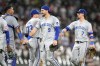 The Kansas City Royals from left, Salvador Perez, Sam Long (73), Vinnie Pasquantino (9) and Bobby Witt Jr. celebrate the team's 4-3 win over the Chicago White Sox after a baseball game Tuesday, July 30, 2024, in Chicago. (AP Photo/Charles Rex Arbogast)
