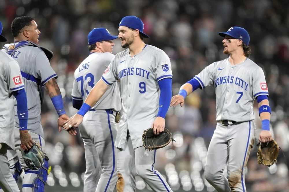 The Kansas City Royals from left, Salvador Perez, Sam Long (73), Vinnie Pasquantino (9) and Bobby Witt Jr. celebrate the team's 4-3 win over the Chicago White Sox after a baseball game Tuesday, July 30, 2024, in Chicago. (AP Photo/Charles Rex Arbogast)