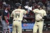 Arizona Diamondbacks' Eugenio Suárez celebrates with Gabriel Moreno (14) after hitting a two-run home run against the Washington Nationals in the first inning during a baseball game, Tuesday, July 30, 2024, in Phoenix. (AP Photo/Rick Scuteri)