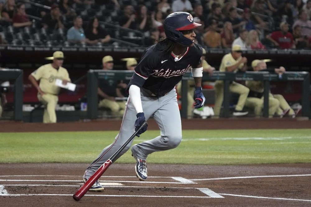 Washington Nationals' CJ Abrams hits a single against the Arizona Diamondbacks in the first inning of a baseball game, Tuesday, July 30, 2024, in Phoenix. (AP Photo/Rick Scuteri)