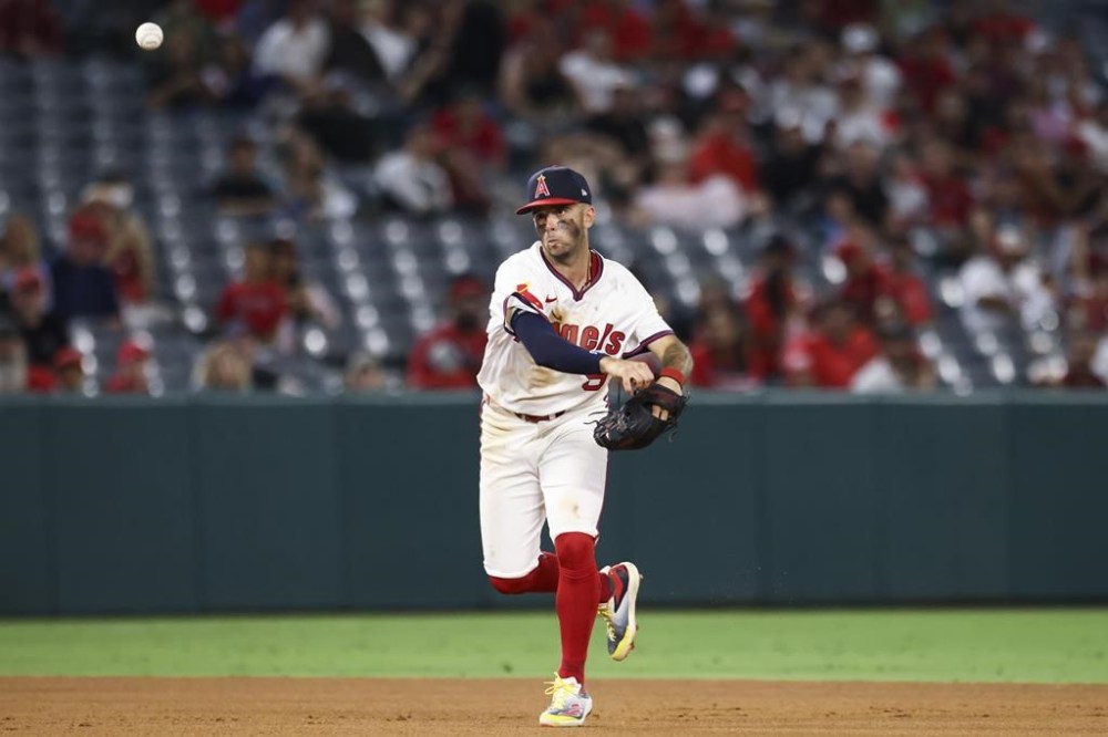Los Angeles Angels shortstop Zach Neto throws to first base during the ninth inning of a baseball game against the Colorado Rockies in Anaheim, Calif., Tuesday, July 30, 2024. (AP Photo/Jessie Alcheh)