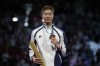 Hong Kong's Cheung Ka long celebrates on the podium after winning the gold medal in the men's individual Foil competition during the 2024 Summer Olympics at the Grand Palais, Monday, July 29, 2024, in Paris, France. (AP Photo/Andrew Medichini)