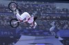 Deng Yawen, of China, performs a trick in front of a video screen during the cycling BMX freestyle women's park final at the 2024 Summer Olympics, Wednesday, July 31, 2024, in Paris, France. (AP Photo/Frank Franklin II)