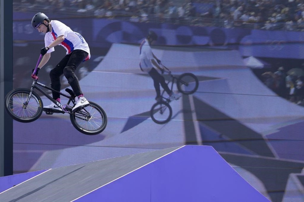 Iveta Miculycova, of the Czech Republic, rides past a video screen during the cycling BMX freestyle women's park final at the 2024 Summer Olympics, Wednesday, July 31, 2024, in Paris, France. (AP Photo/Frank Franklin II)