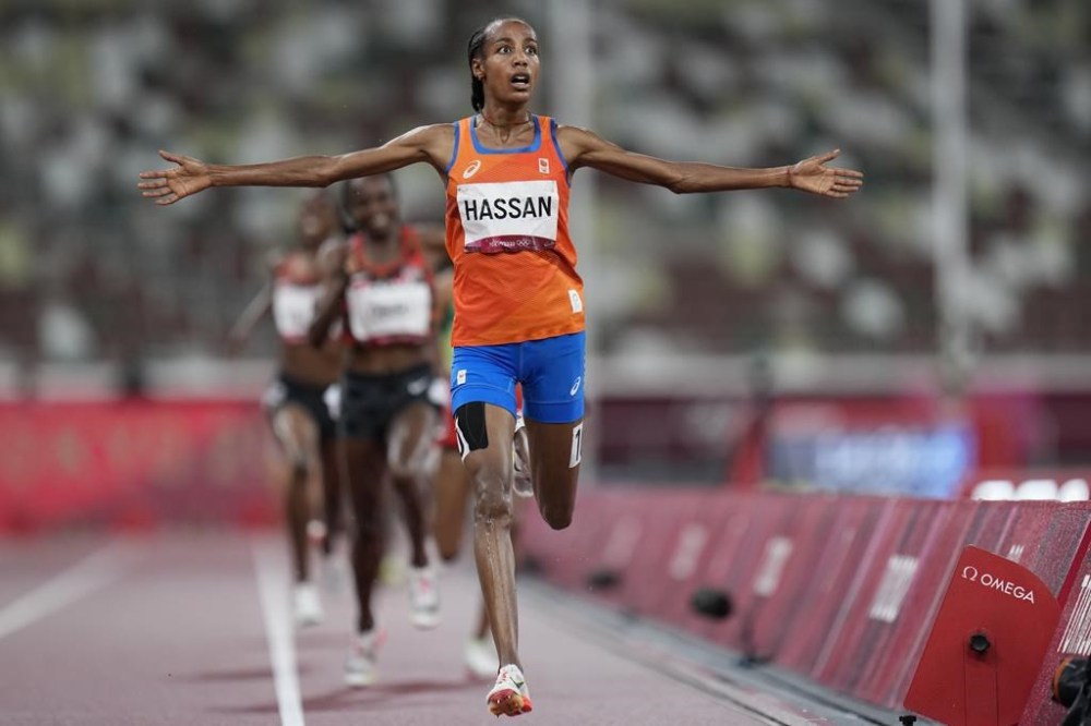 FILE - Sifan Hassan, of the Netherlands, celebrates as she crosses the finish line to win the women's 5,000-meters final at the 2020 Summer Olympics, Monday, Aug. 2, 2021, in Tokyo. (AP Photo/Petr David Josek, File)