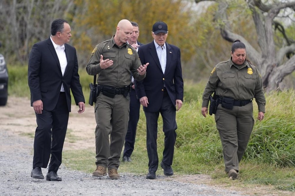 FILE - President Joe Biden, center, looks over the southern border, Feb. 29, 2024, in Brownsville, Texas. Walking with Biden are from l-r., Peter Flores, Deputy Commissioner, U.S. Customs and Border Protection, Jason Owens, Chief, U.S. Border Patrol and Gloria Chavez, Sector Chief, U.S. Border Patrol. U.S. authorities say border arrests during July have plummeted to a new low for Joe Biden’s presidency, raising prospects that a temporary ban on asylum may be lifted soon. (AP Photo/Evan Vucci, File)