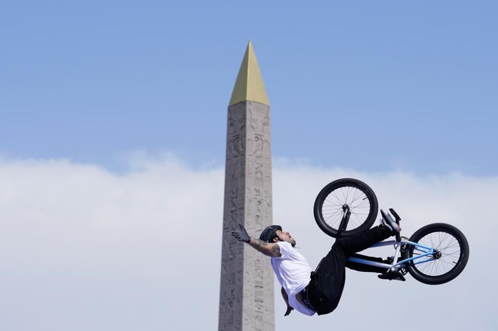 Gil Jose Torres, of Argentina, performs a trick, with the Luxor Obelisk of La Concorde square in the background, during the cycling BMX freestyle women's park final at the 2024 Summer Olympics, Wednesday, July 31, 2024, in Paris, France. (AP Photo/Frank Franklin II)