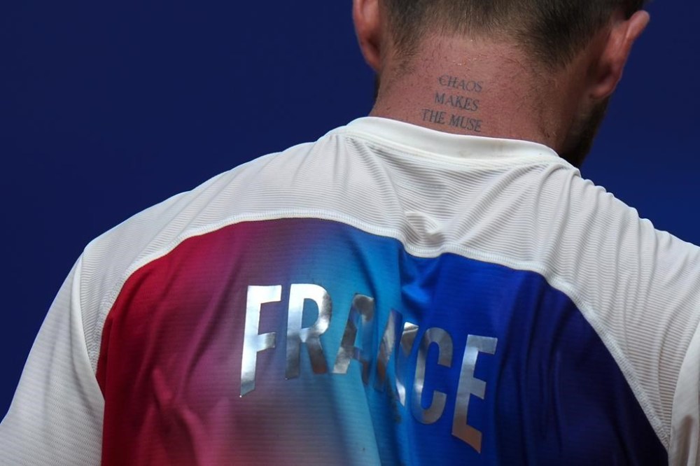 Corentin Moutet of France wipes his sweat as he plays Tommy Paul of the United States during their men's singles third round match, at the 2024 Summer Olympics, Wednesday, July 31, 2024, at the Roland Garros stadium in Paris, France. (AP Photo/Andy Wong)
