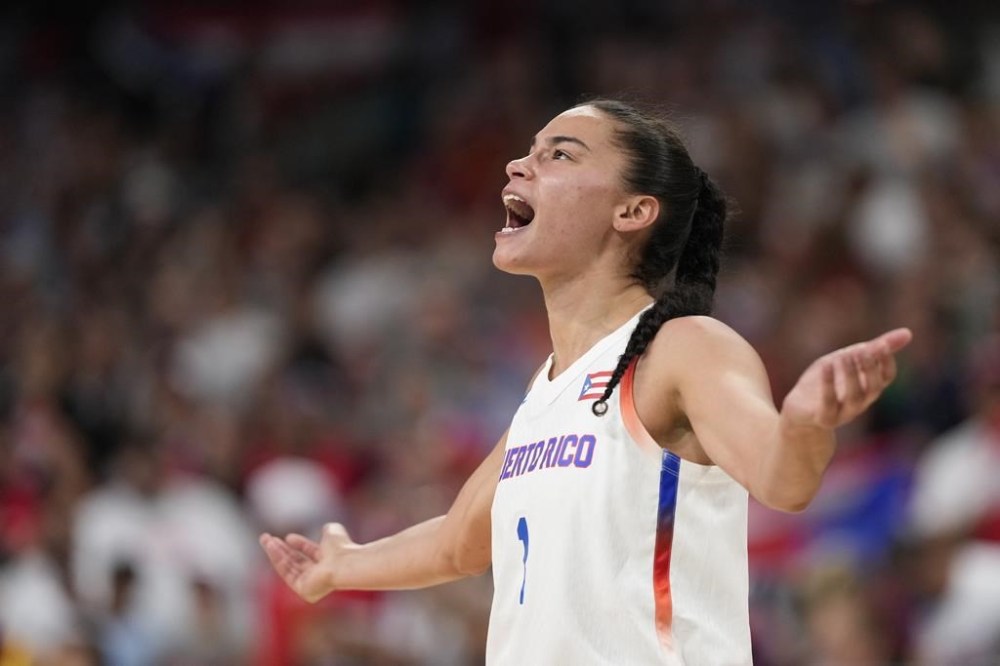 Tayra Melendez, of Puerto Rico, tries to fire ups the crowd in a women's basketball game against Spain at the 2024 Summer Olympics, Wednesday, July 31, 2024, in Villeneuve-d'Ascq, France. (AP Photo/Mark J. Terrill)