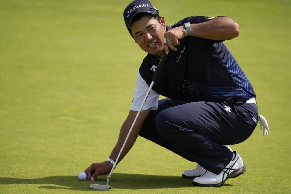 Hideki Matsuyama, of Japan, places his ball on the 13th green during a practice round for the men's golf event at the 2024 Summer Olympics, Wednesday, July 31, 2024, at Le Golf National in Saint-Quentin-en-Yvelines, France. (AP Photo/George Walker IV)
