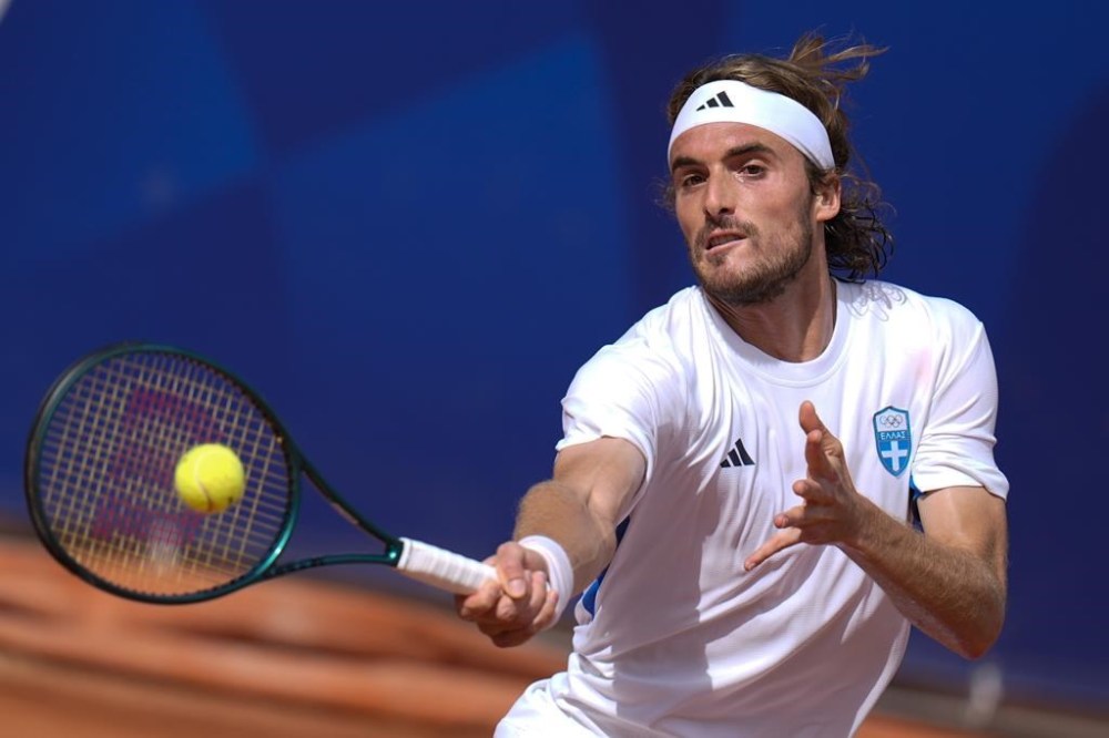 Stefanos Tsitsipas of Greece hits a forehand shot to Zizou Bergs of Belgium during the men's singles tennis competition, at the 2024 Summer Olympics, Sunday, July 28, 2024, in Paris, France. (AP Photo/Andy Wong)