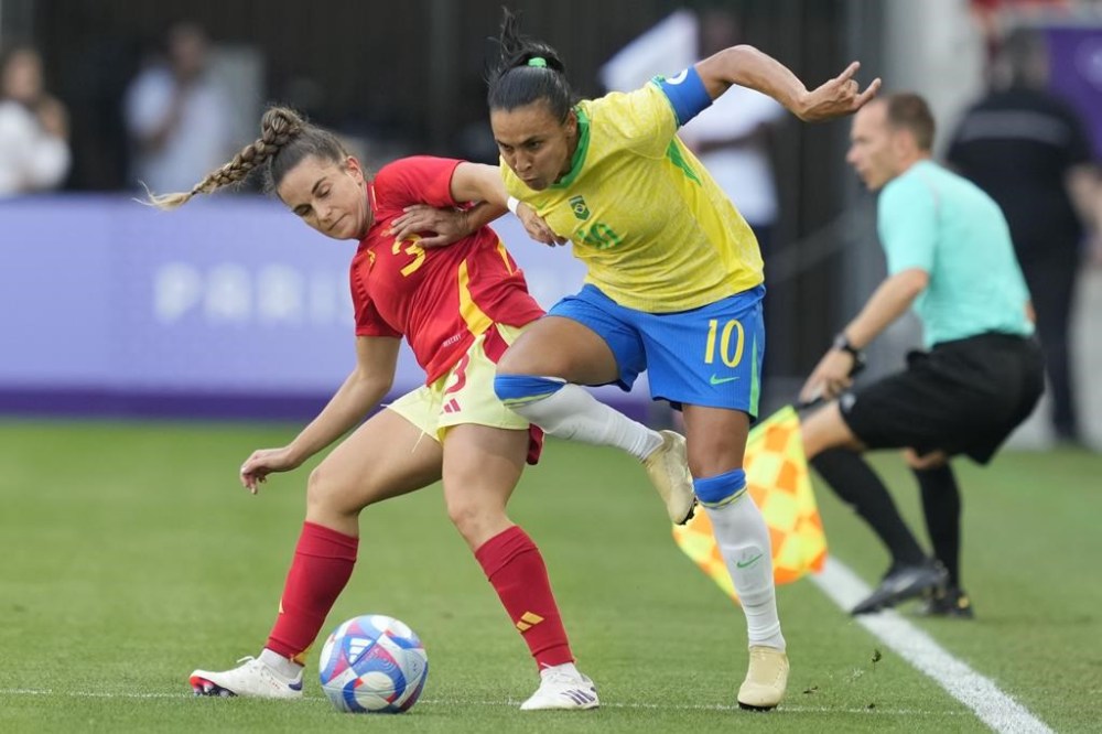 Brazil's Marta, right, and Spain's Teresa Abelleira battle for the ball during a women's Group C soccer match between Brazil and Spain, at Bordeaux Stadium, during the 2024 Summer Olympics, Wednesday, July 31, 2024, in Bordeaux, France. (AP Photo/Moises Castillo)
