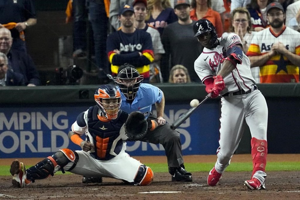 FILE - Atlanta Braves' Jorge Soler hits a three-run home run during the third inning in Game 6 of baseball's World Series between the Houston Astros and the Atlanta Braves Tuesday, Nov. 2, 2021, in Houston. The Braves would love to see him recreate that magic as they prepare for another postseason run by continuing to reunite members of that championship team. (AP Photo/Sue Ogrocki, File)