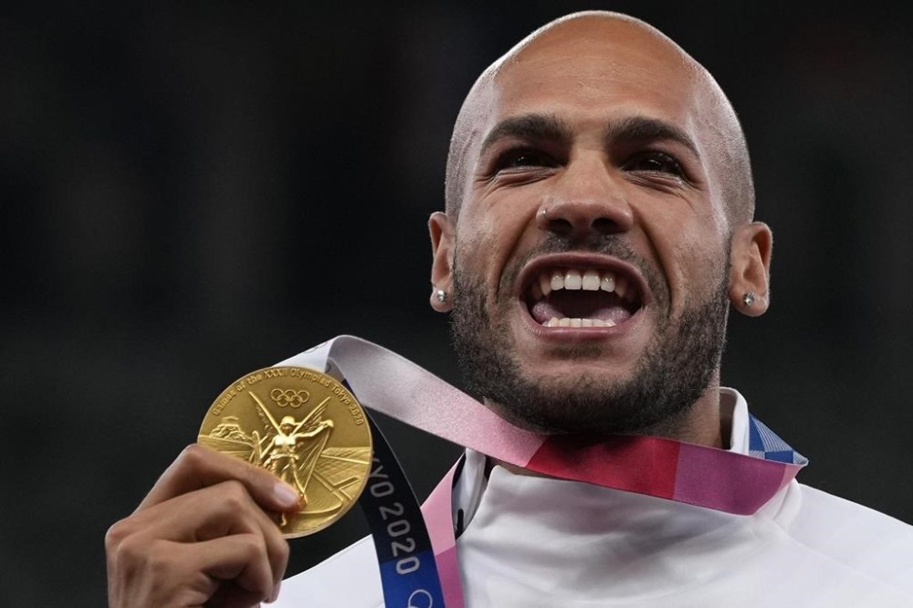 FILE - Lamont Marcell Jacobs, of Italy poses with his gold medal following the men's 100-meters final at the 2020 Summer Olympics, Monday, Aug. 2, 2021, in Tokyo. (AP Photo/Francisco Seco, File)