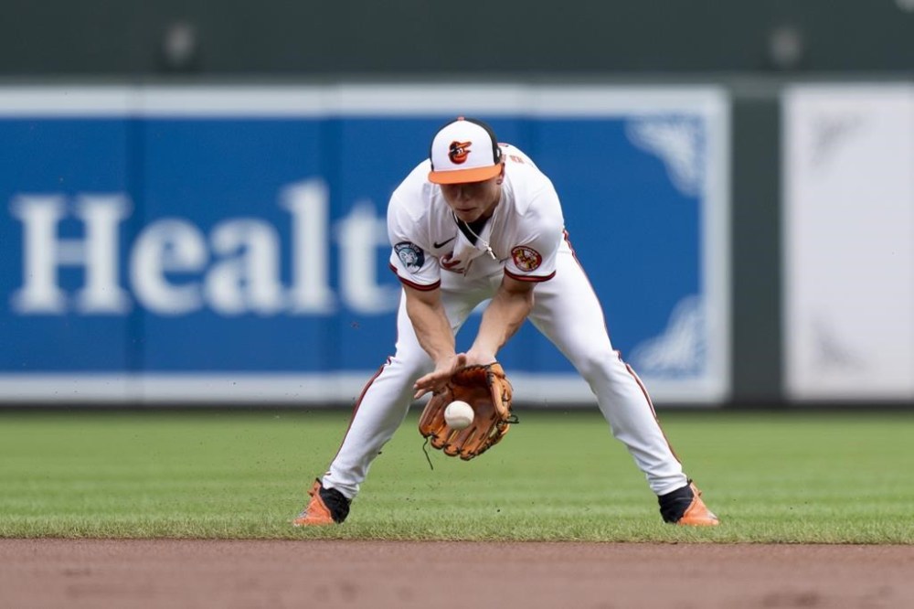 Baltimore Orioles second baseman Jackson Holliday fields a ground ball hit in by Toronto Blue Jays' Spencer Horwitz before throwing to first for an out during the first inning of a baseball game, Wednesday, July 31, 2024, in Baltimore. (AP Photo/Stephanie Scarbrough)